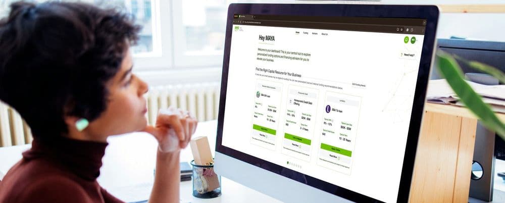 Person thoughtfully reviewing an online bill payment interface on a desktop computer.